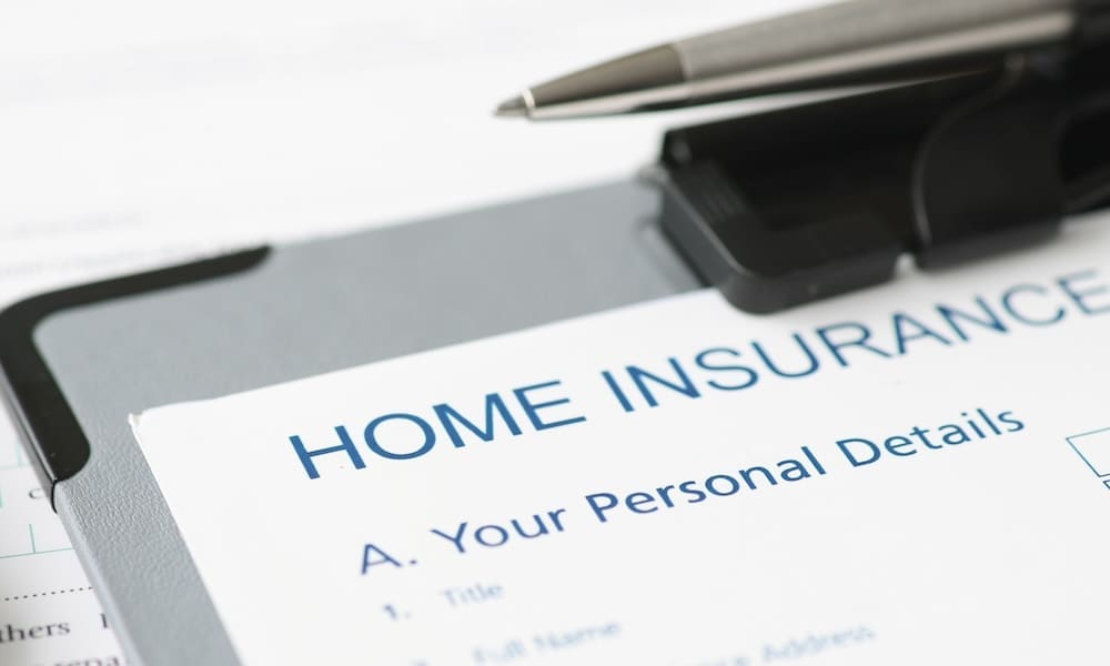 Does Homeowners Insurance Really Increase Every Year? - Clipboard with a home insurance application next to a pen and additional papers